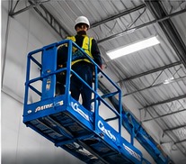 Low-voltage technician performing elevated work from an aerial lift